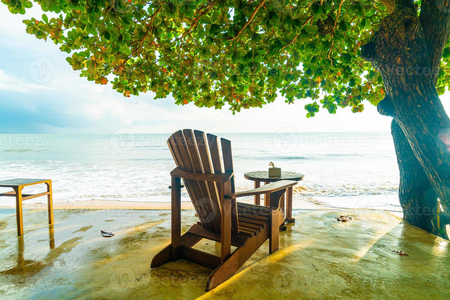 Empty wooden chairs with beach sea background photo
