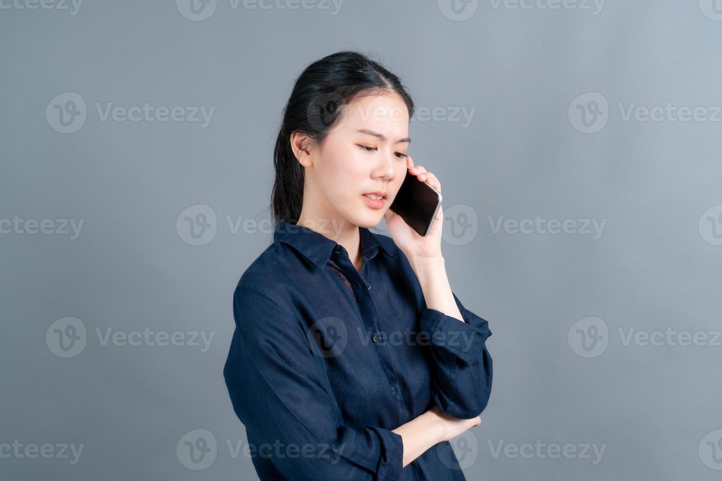 Asian woman using mobile phone talking business photo