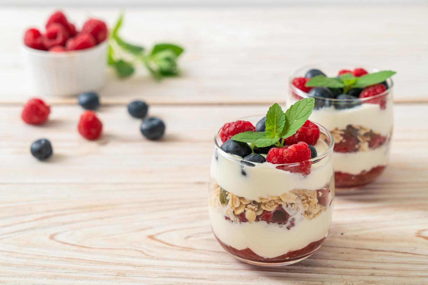 Homemade raspberry and blueberry with yogurt and granola - healthy food style photo