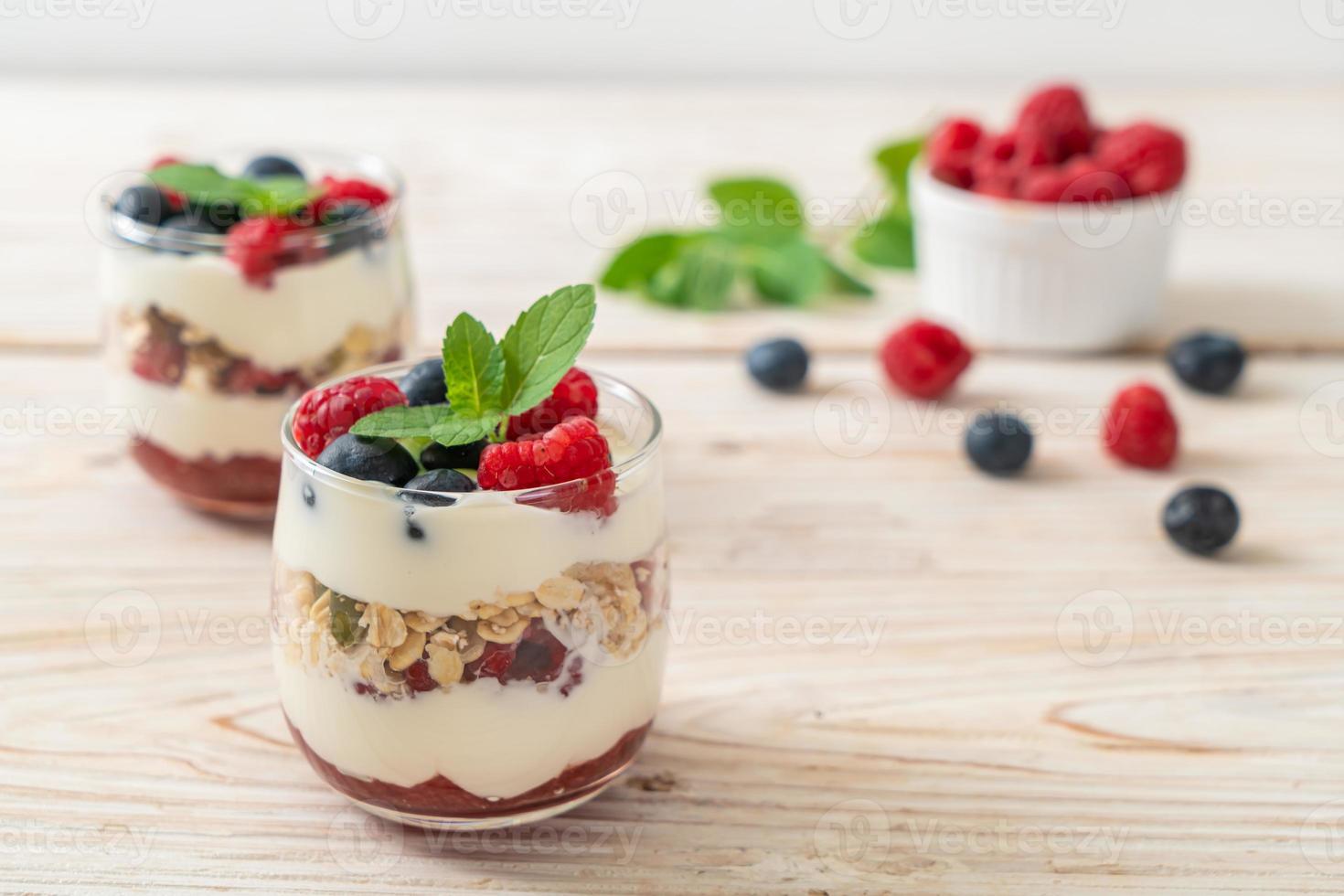 Homemade raspberry and blueberry with yogurt and granola - healthy food style photo