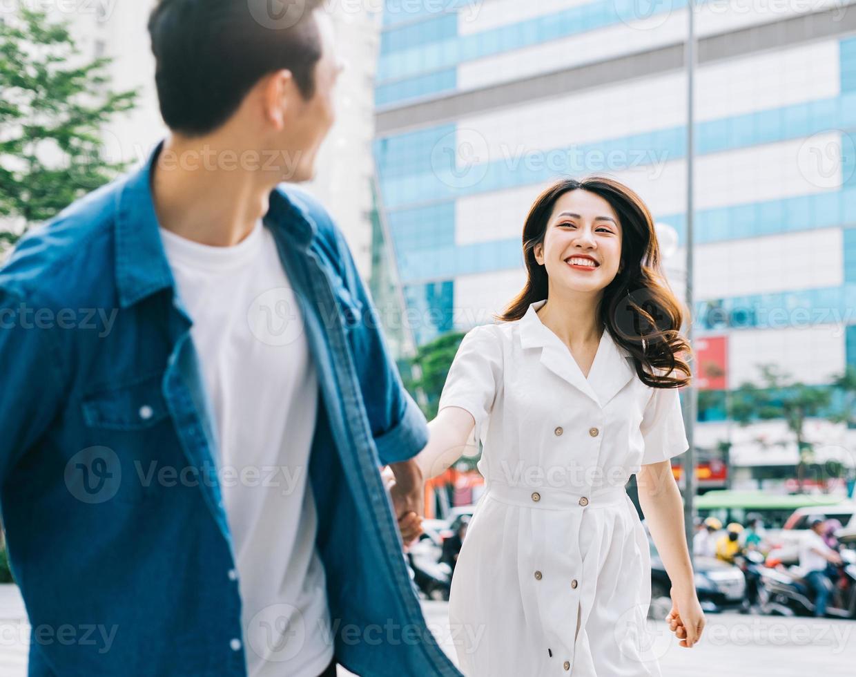 Young Asian couple walking on the street photo