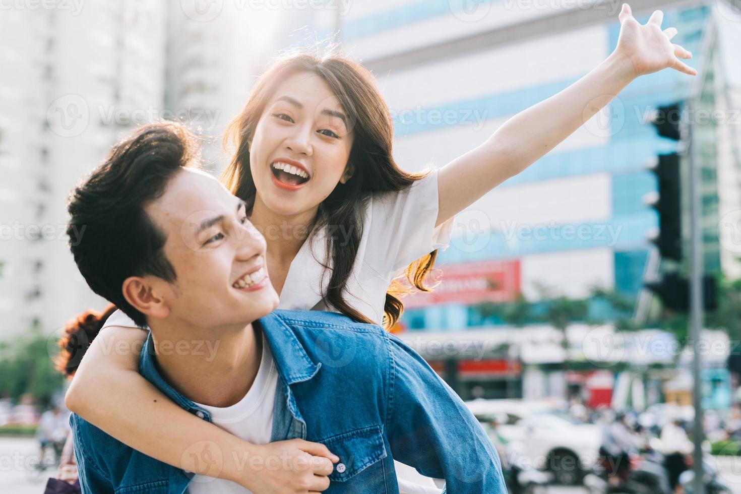 Boyfriend is carrying his girlfriend on his back photo