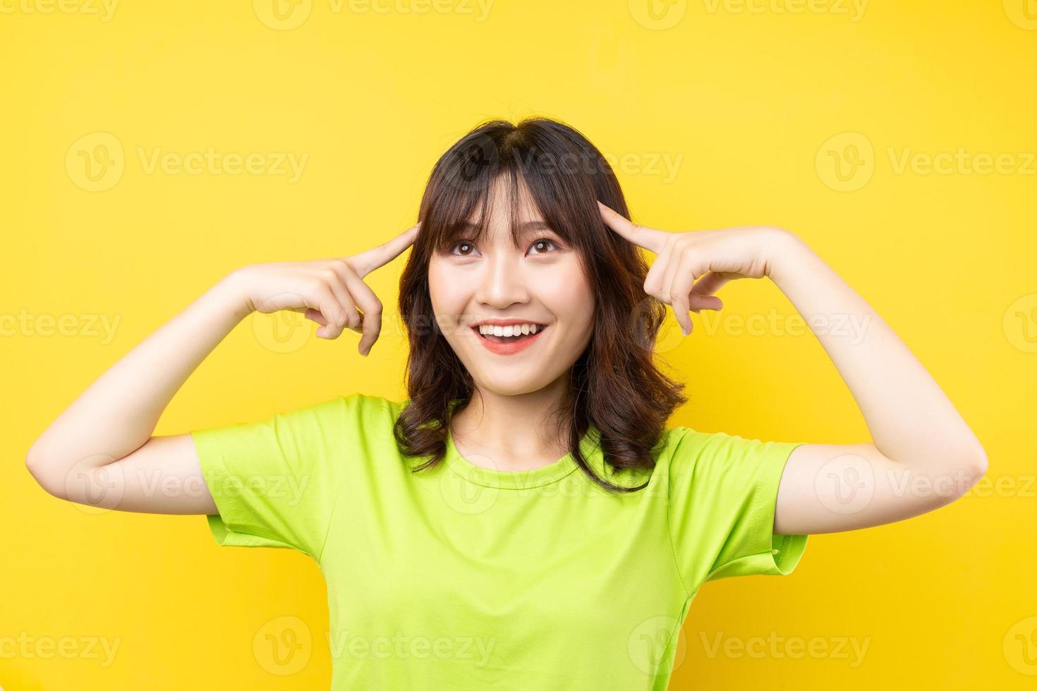 Young Asian girl with expressions and gestures on background photo
