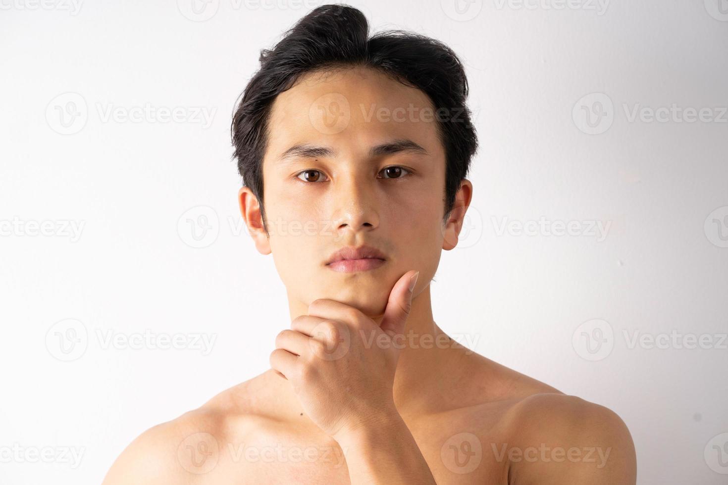 Portrait of handsome young man with clean muscles and skin photo