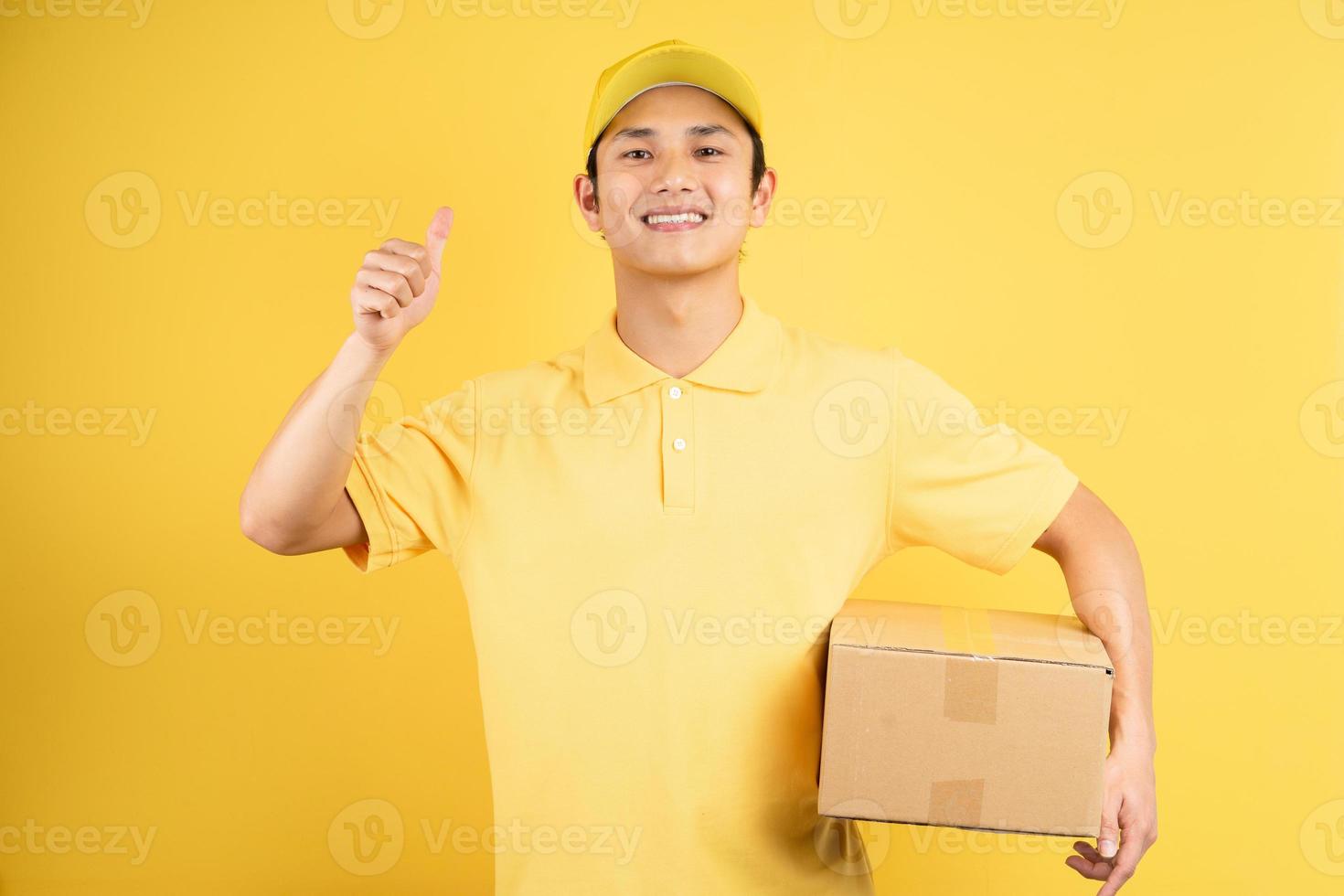 Portrait of a male delivery man holding a cargo box, background photo