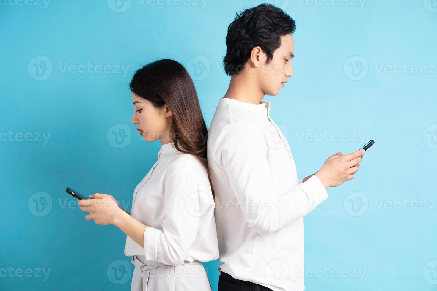 retrato, de, pareja joven, utilizar, teléfono, en, plano de fondo foto