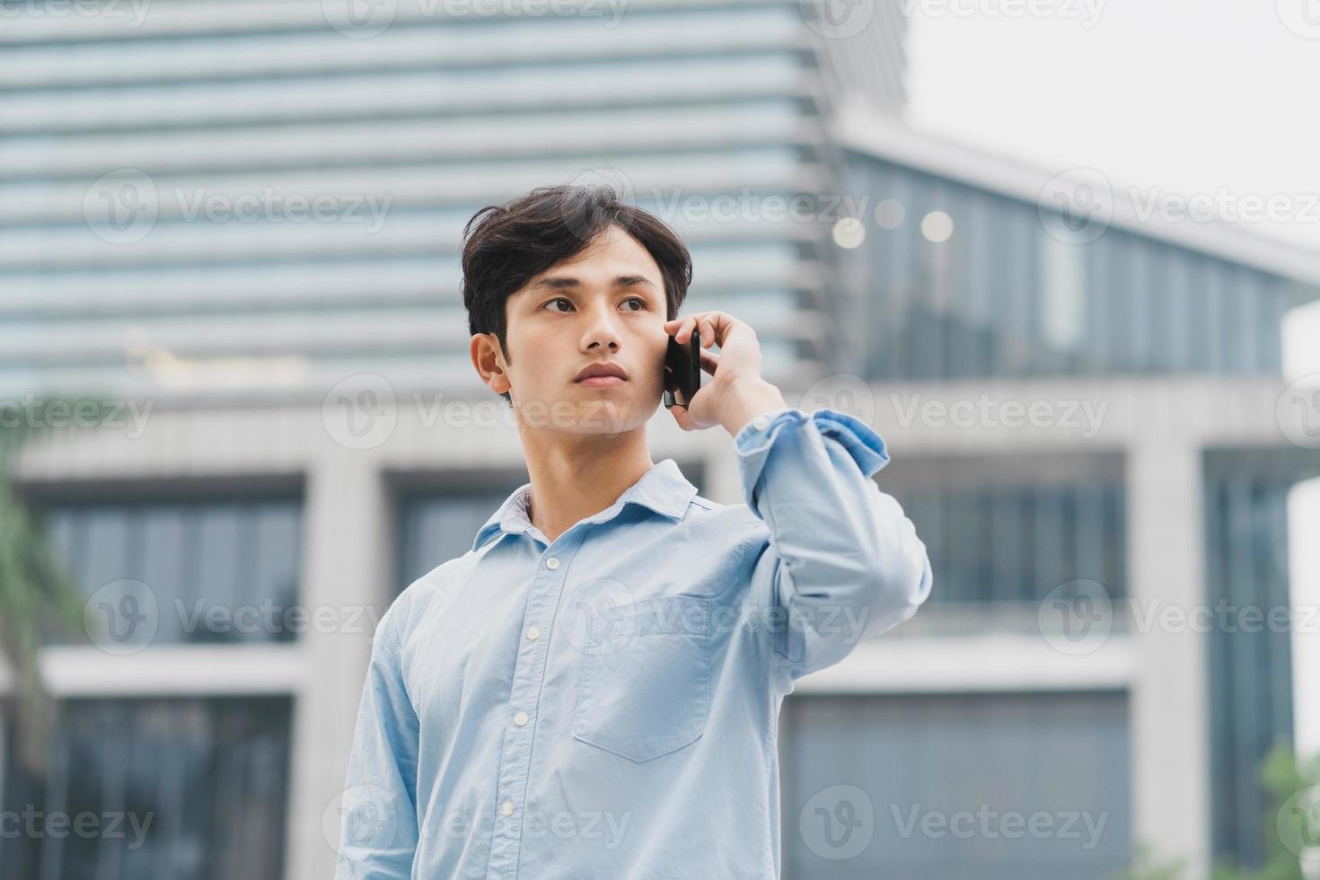 Asian businessman is calling outside photo