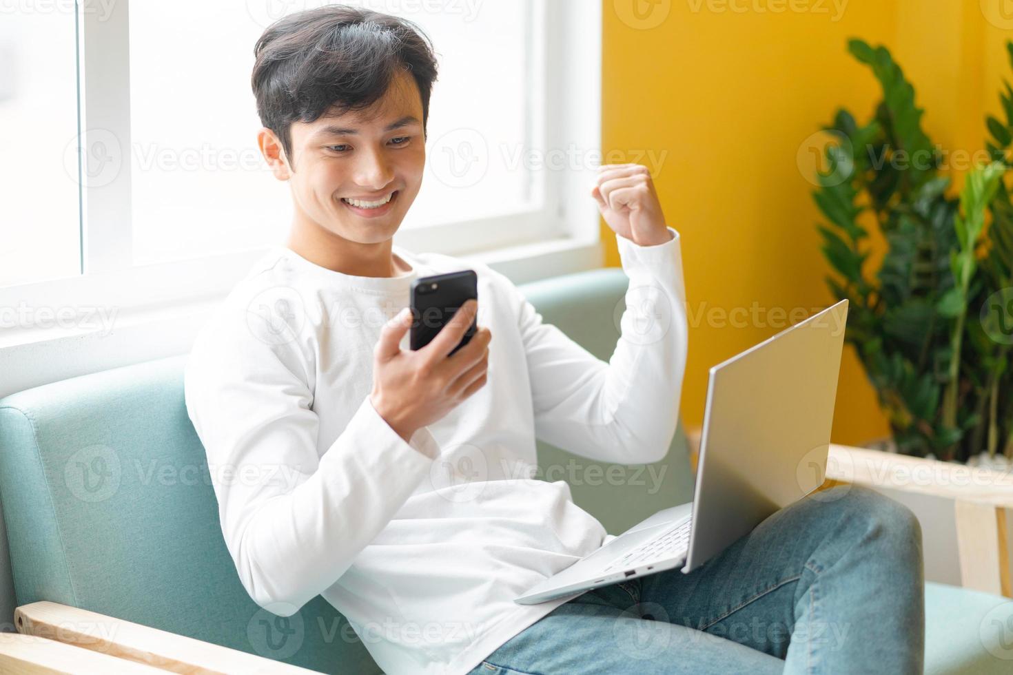 Young Asian man sitting working at home photo