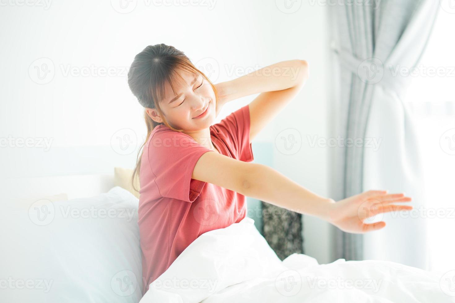 Young Asian woman wake up in early morning photo