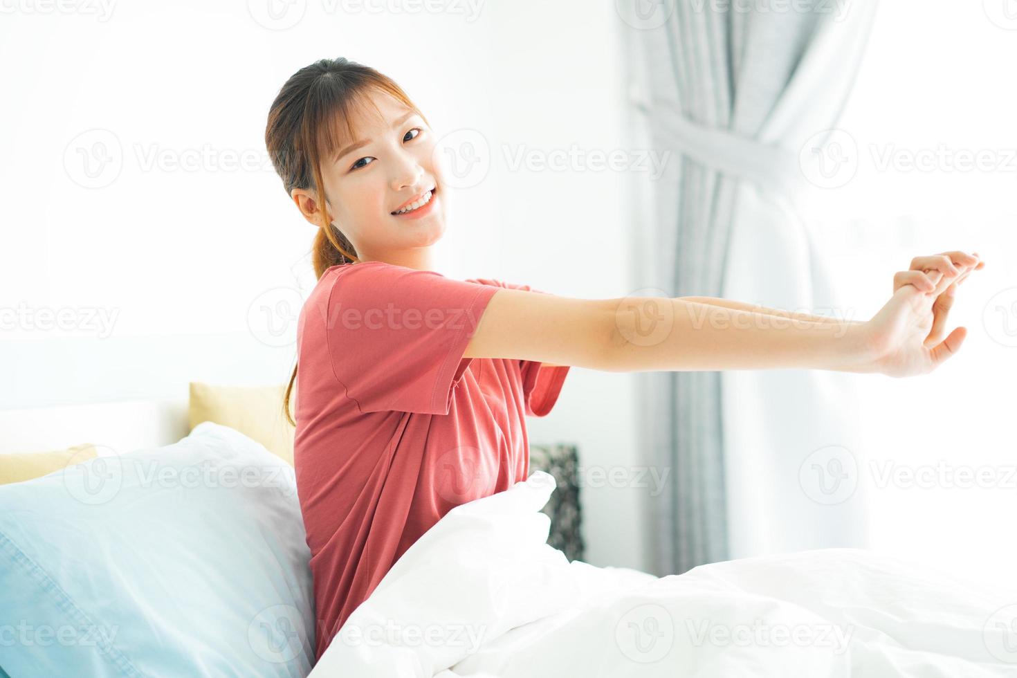 Young Asian woman wake up in early morning photo
