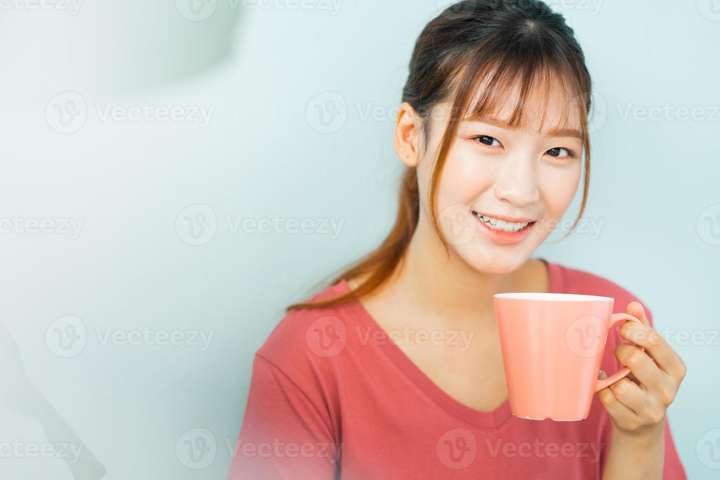 Young Asian woman drink coffee in the morning photo