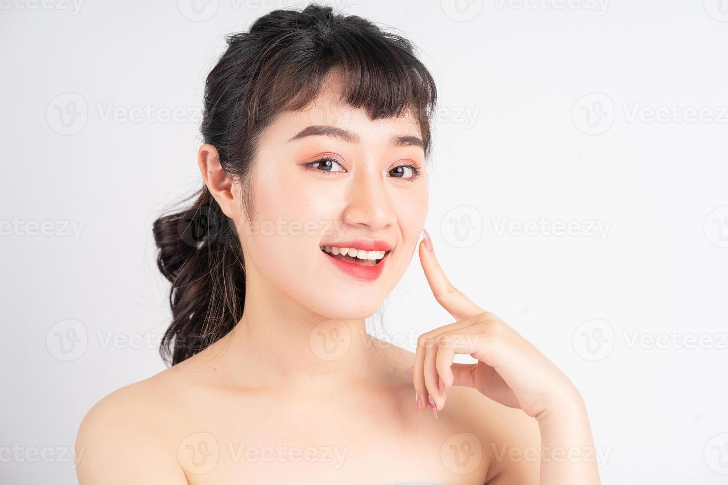 Young Asian woman with beautiful skin on white background photo