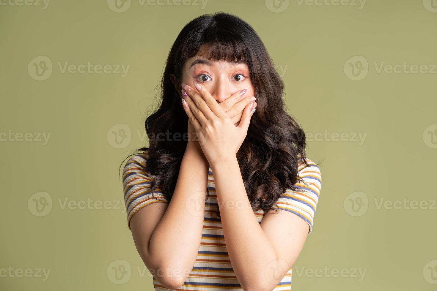 Young beautiful Asian woman posing on background photo