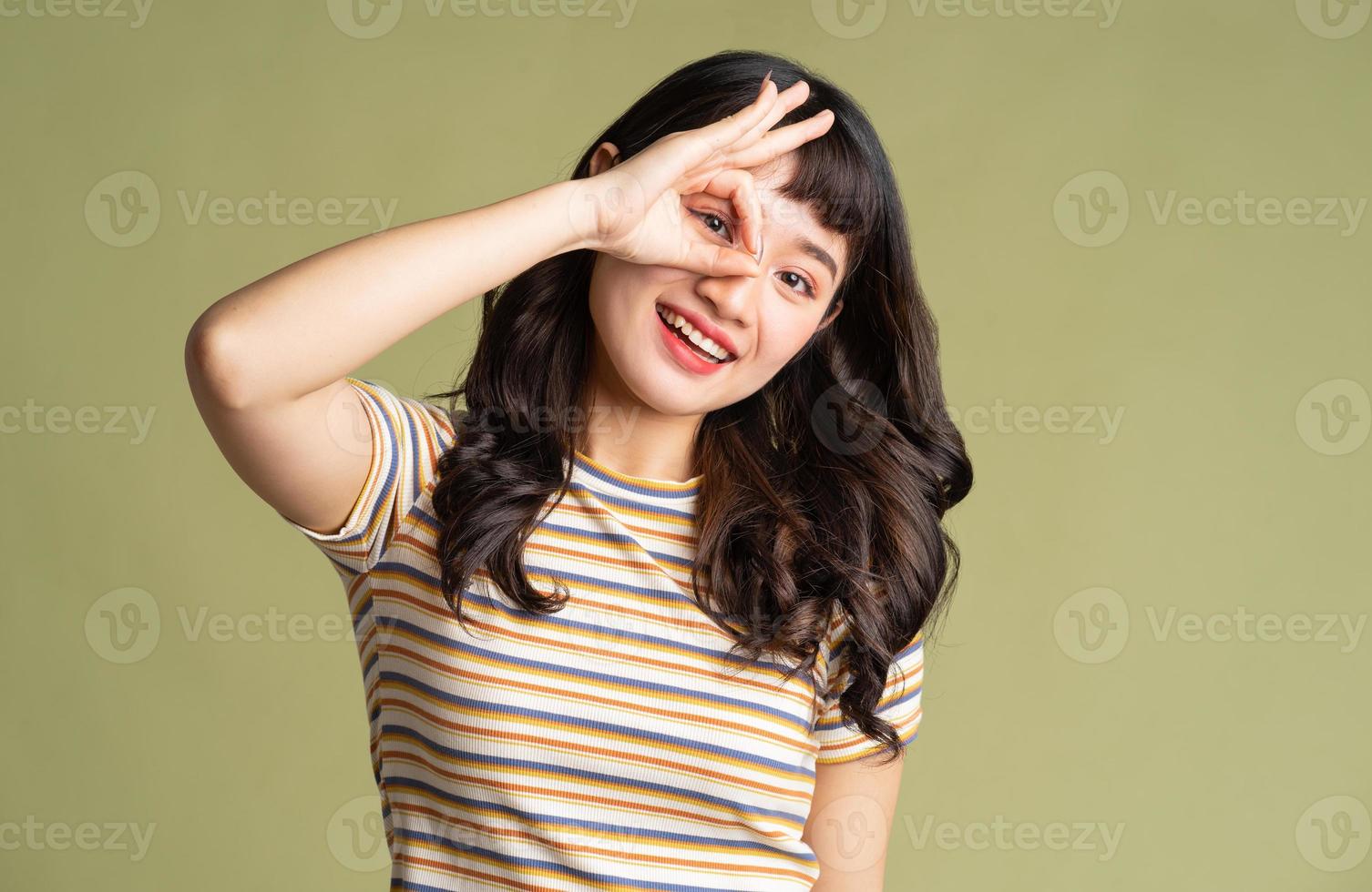 Young beautiful Asian woman posing on background photo