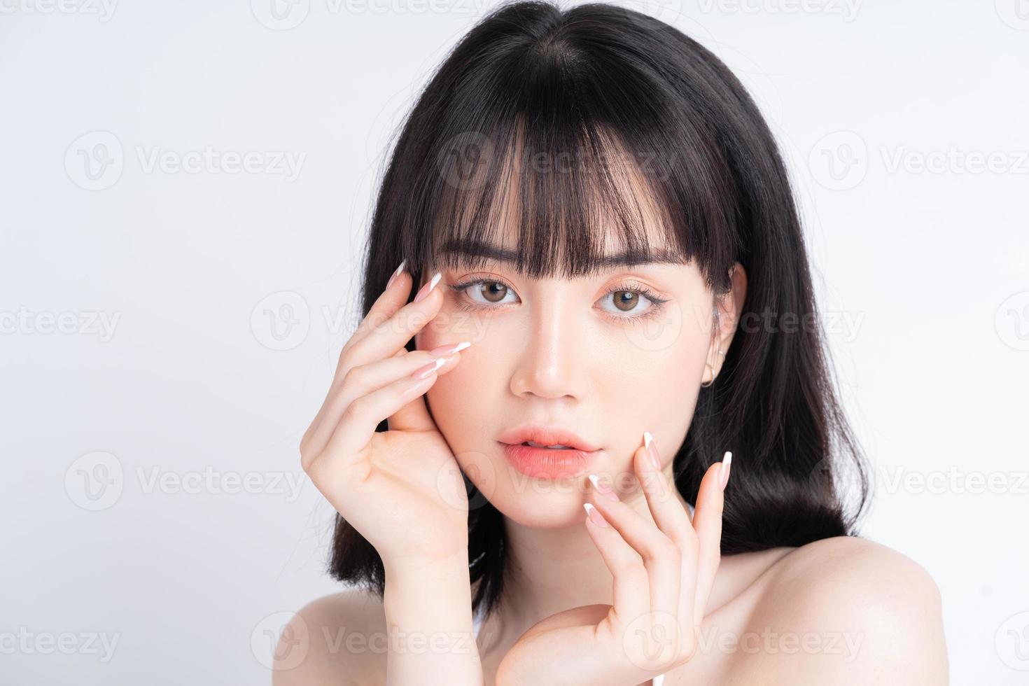 Attractive young Asian woman with fresh skin. Face care, facial treatment, , woman beauty skin isolated on white background. cosmetology, beauty skin and cosmetic concept photo