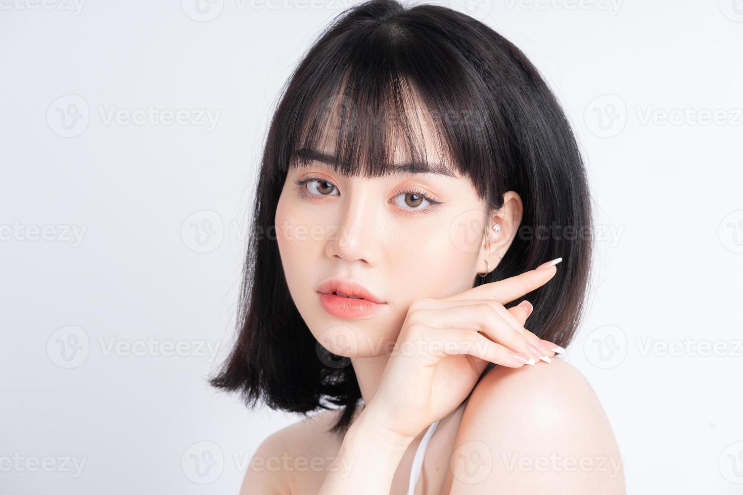 Attractive young Asian woman with fresh skin. Face care, facial treatment, , woman beauty skin isolated on white background. cosmetology, beauty skin and cosmetic concept photo