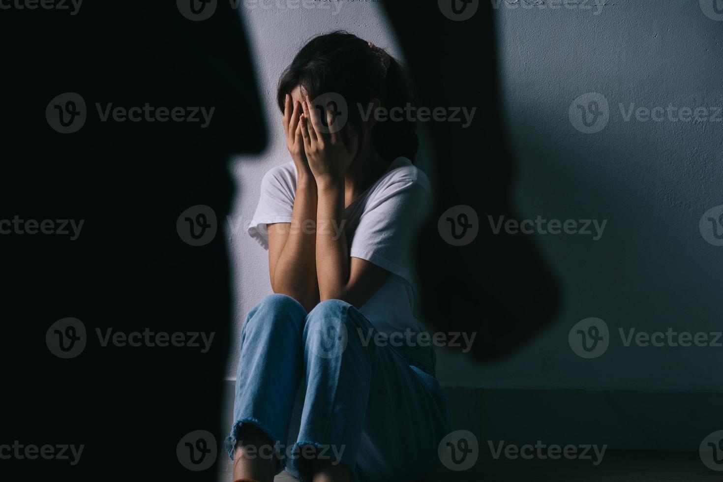 Asian woman hugging her face and crying because of her boyfriend's violence photo