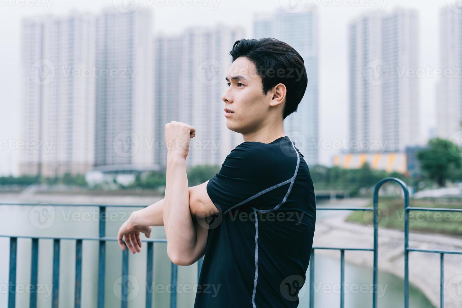 Young Asian man exercising in park photo