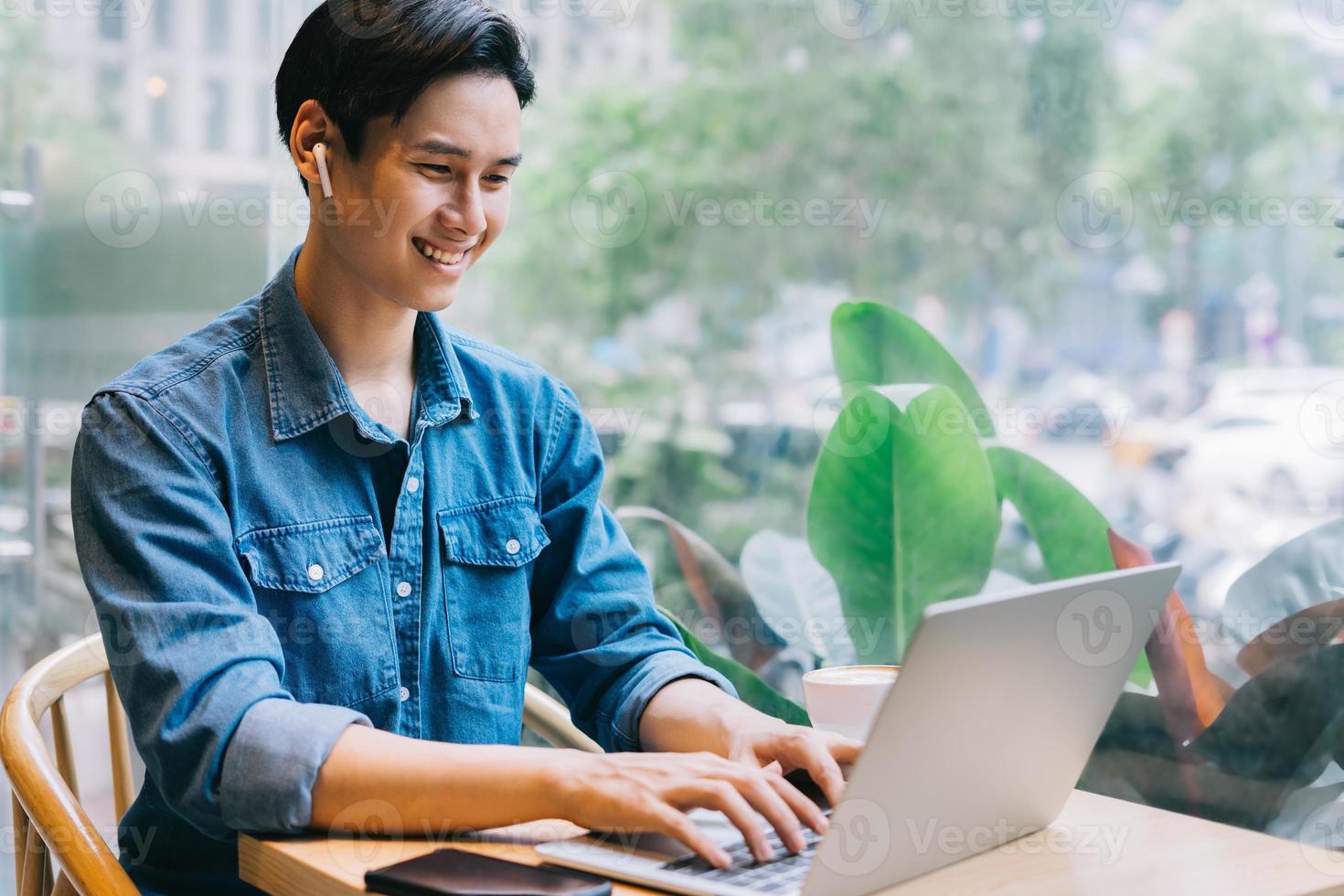 Asian man working at cafe on weekend photo