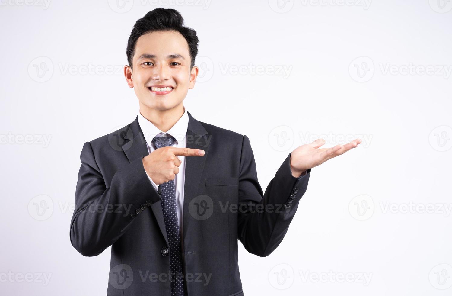 Image of young Asian businessman wearing suit on white background photo