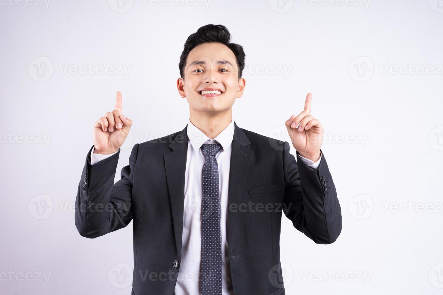 Image of young Asian businessman wearing suit on white background photo