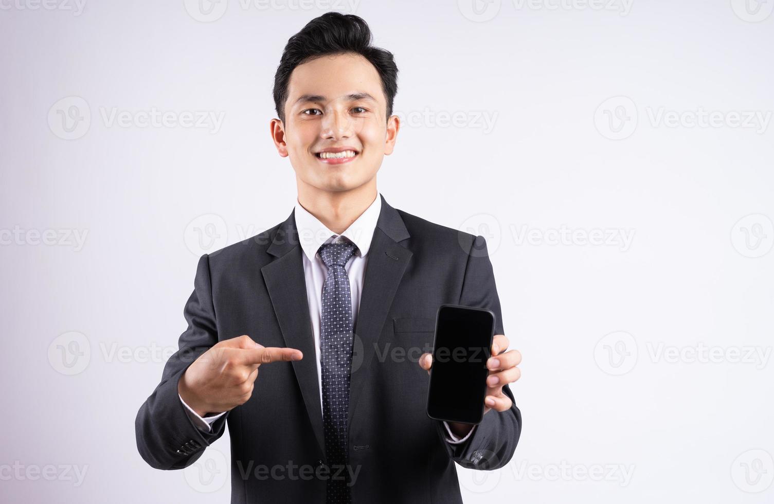 Image of young Asian businessman wearing suit on white background photo