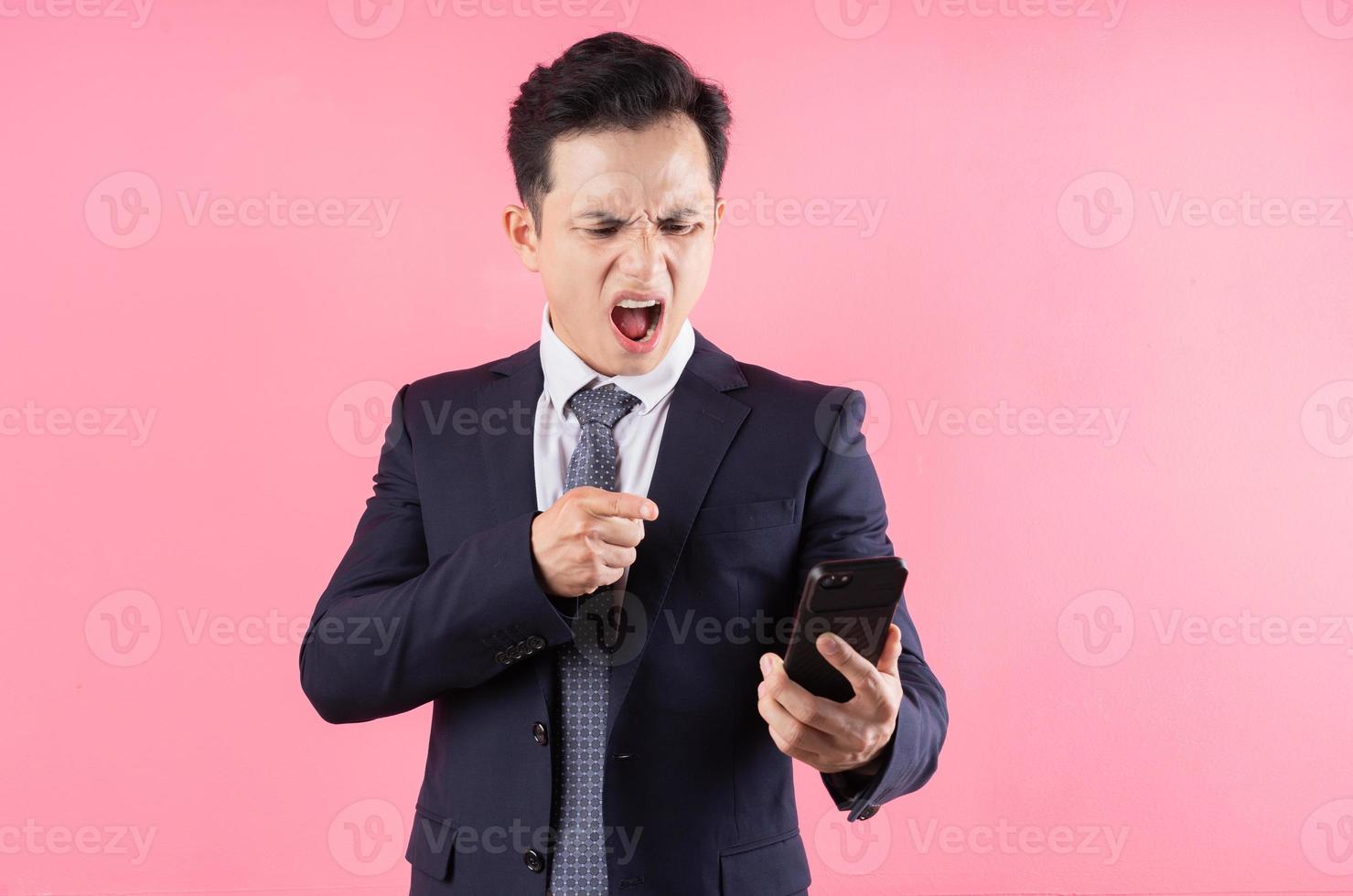 Image of young Asian businessman on pink background photo