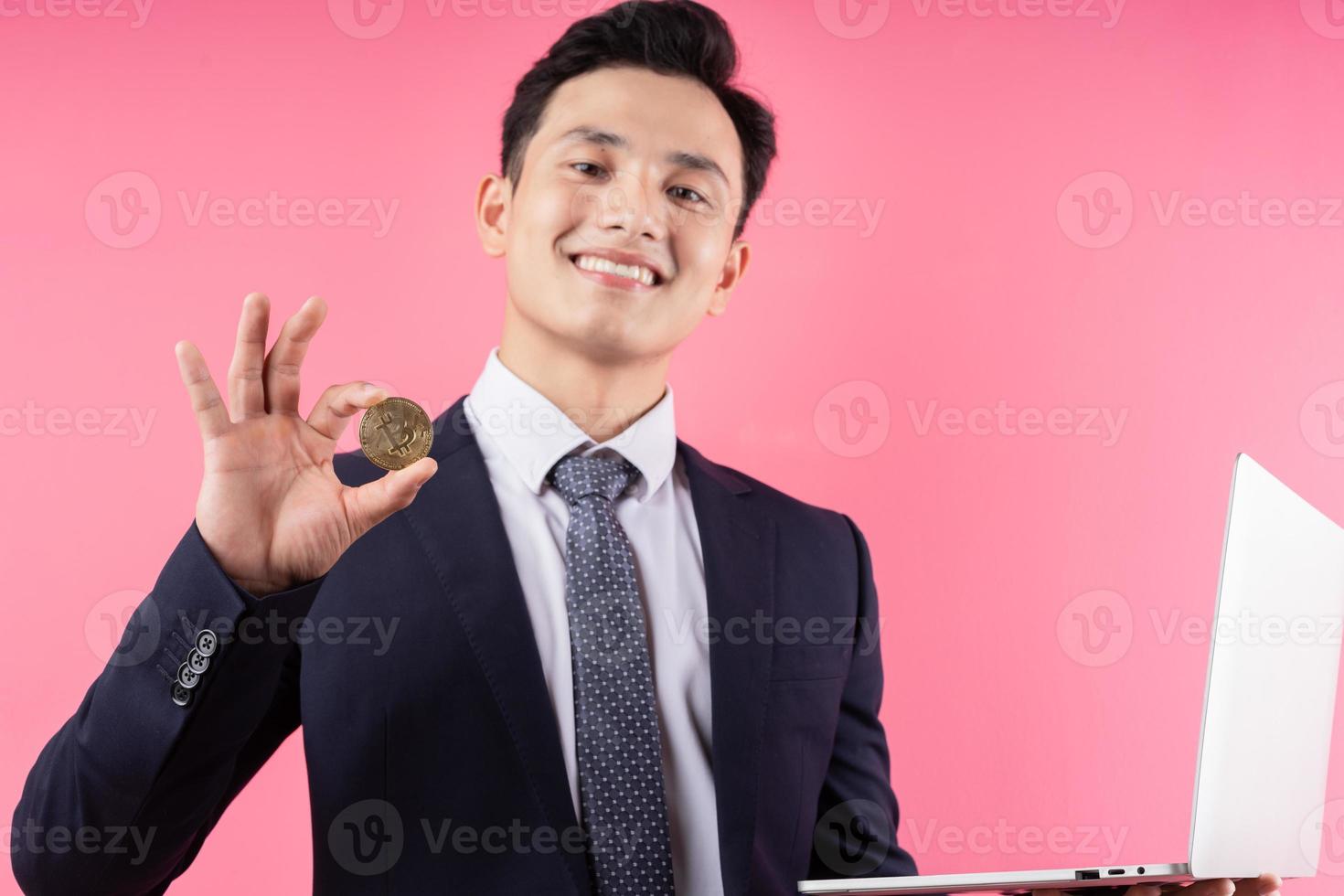 Image of young Asian businessman on pink background photo