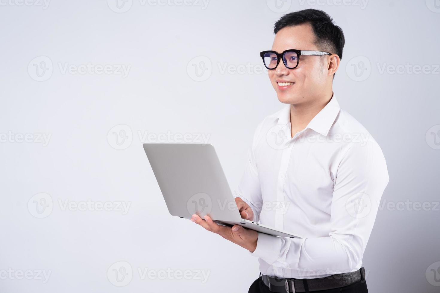 Asian businessman using laptop on white background photo