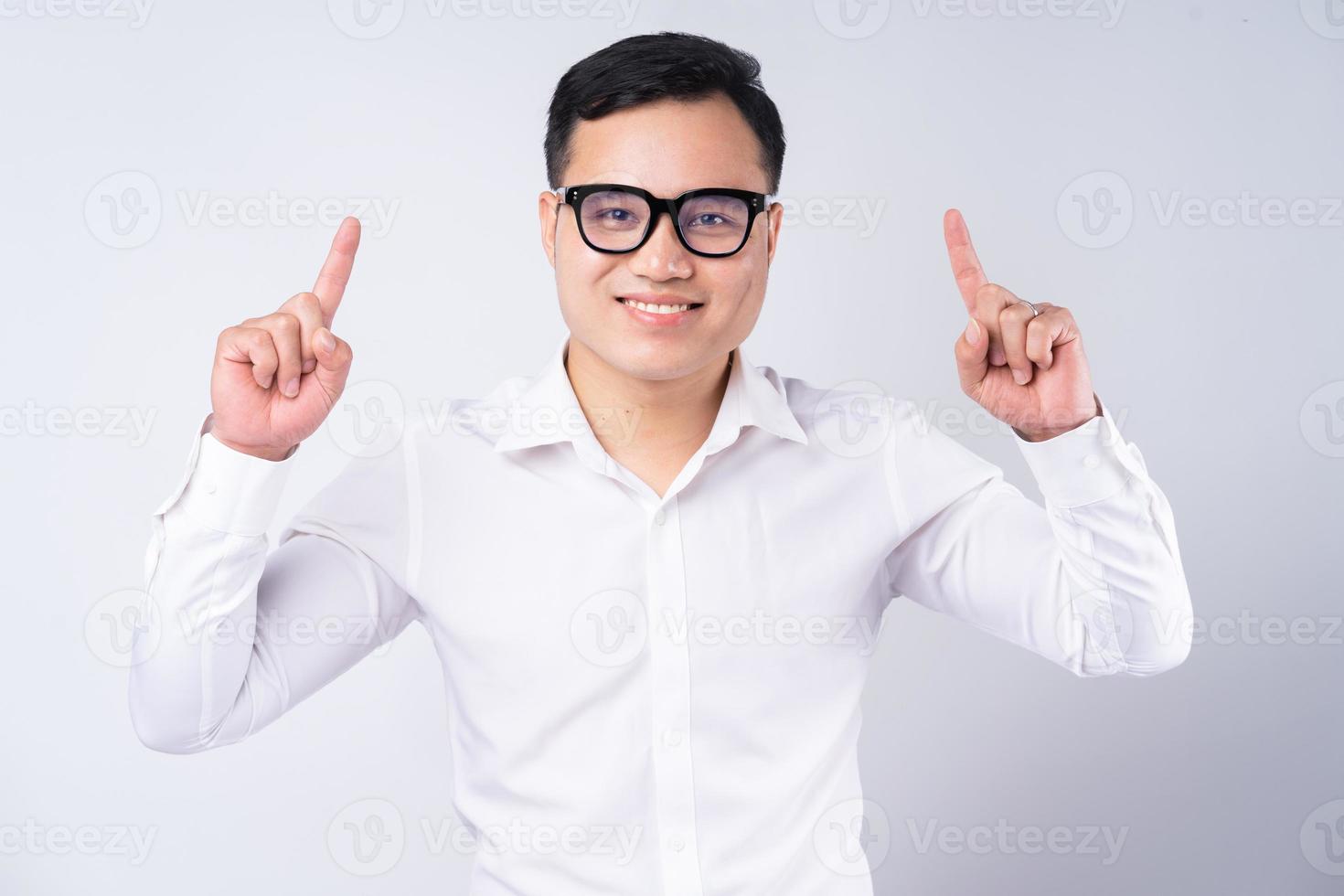 Image of Asian businessman pointing up photo