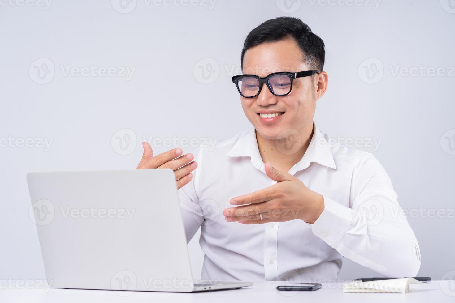 Image of Asian businessman calling to his friends photo