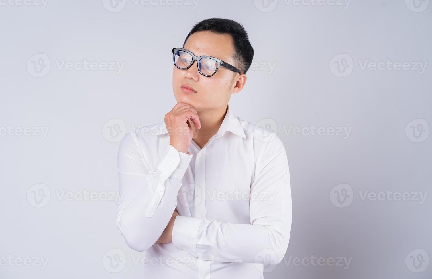 Image of Asian businessman pondering photo