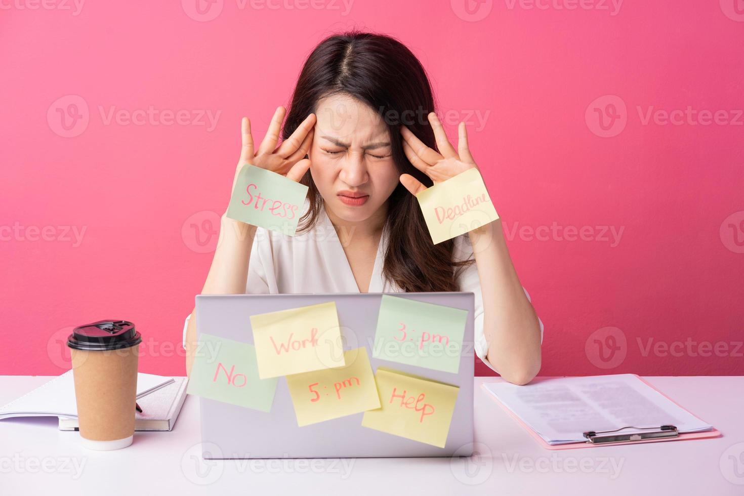 Young Asian businesswoman sitting working with expression on background photo