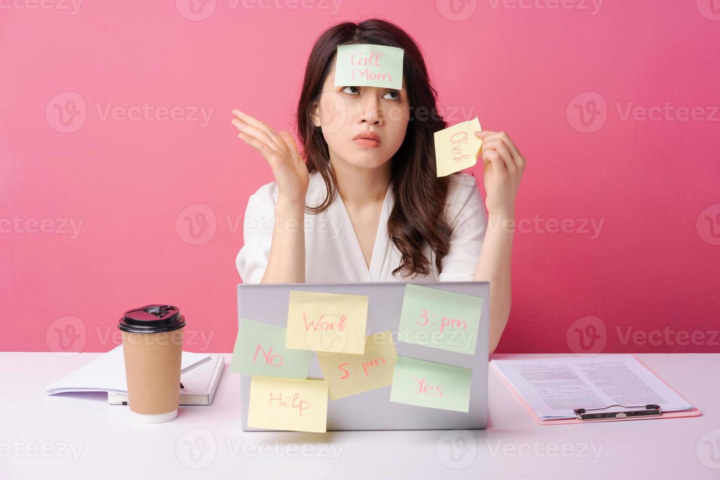Young Asian businesswoman sitting working with expression on background photo