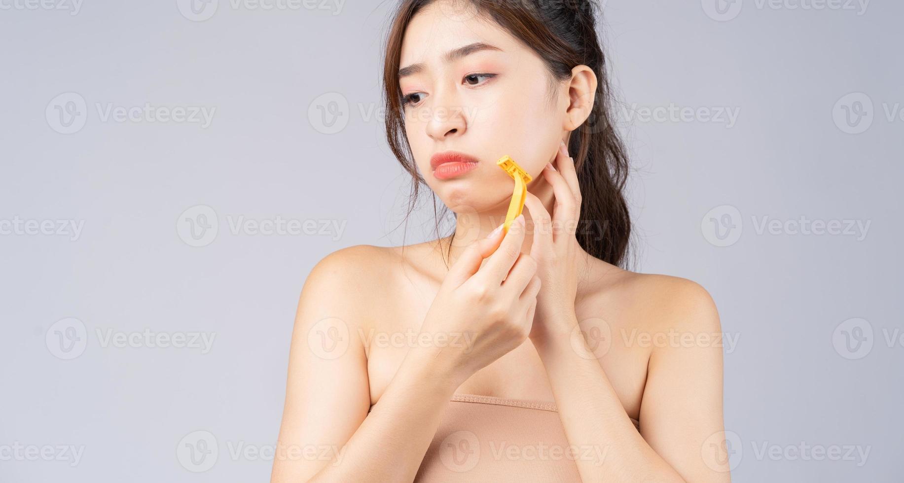 Young Asian girl worried about facial hair photo