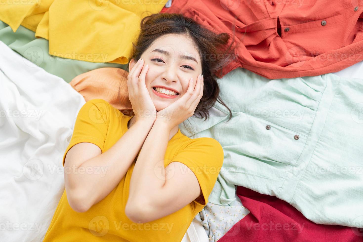 Asian girl stuck in her mess of clothes photo