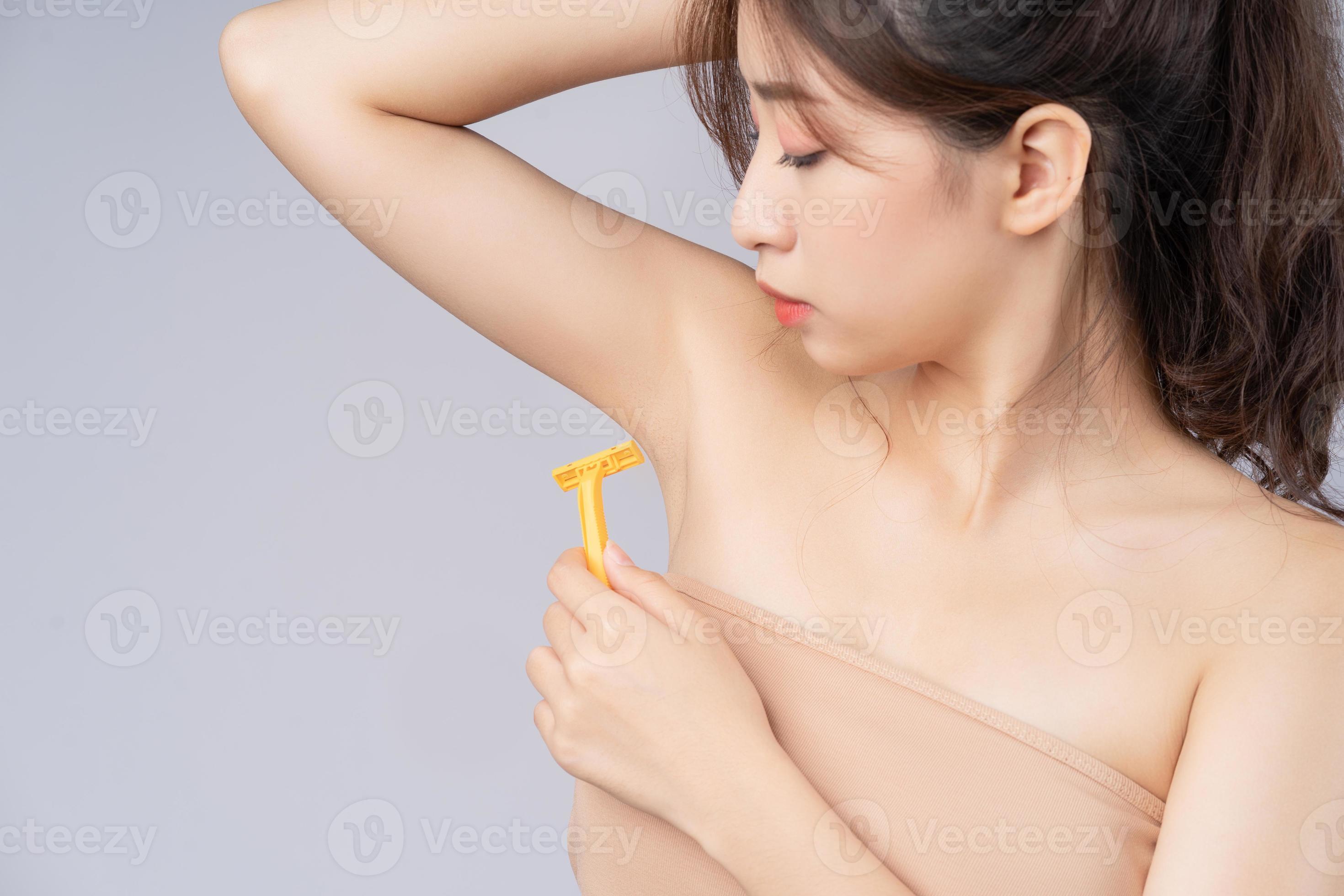 Young girl with armpit hair Young Asian girl is using a razor to shave armpit hair 2877244 Stock Photo  at Vecteezy