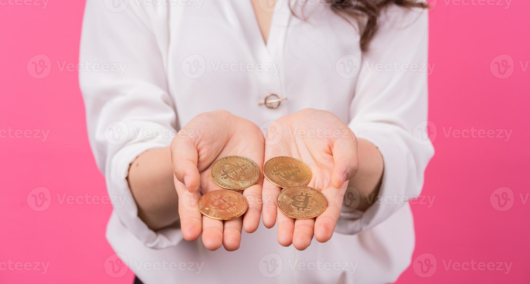 Asian businesswoman holding bitcoin in her hand photo