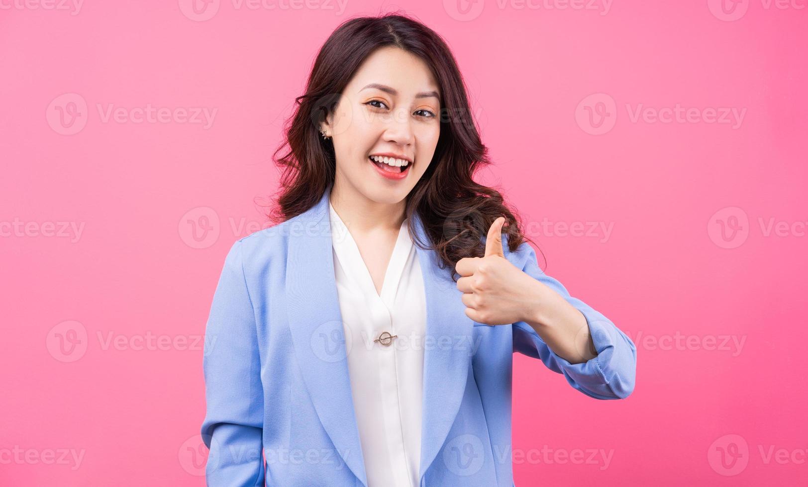 Image of Asian businesswoman on pink bakcground photo