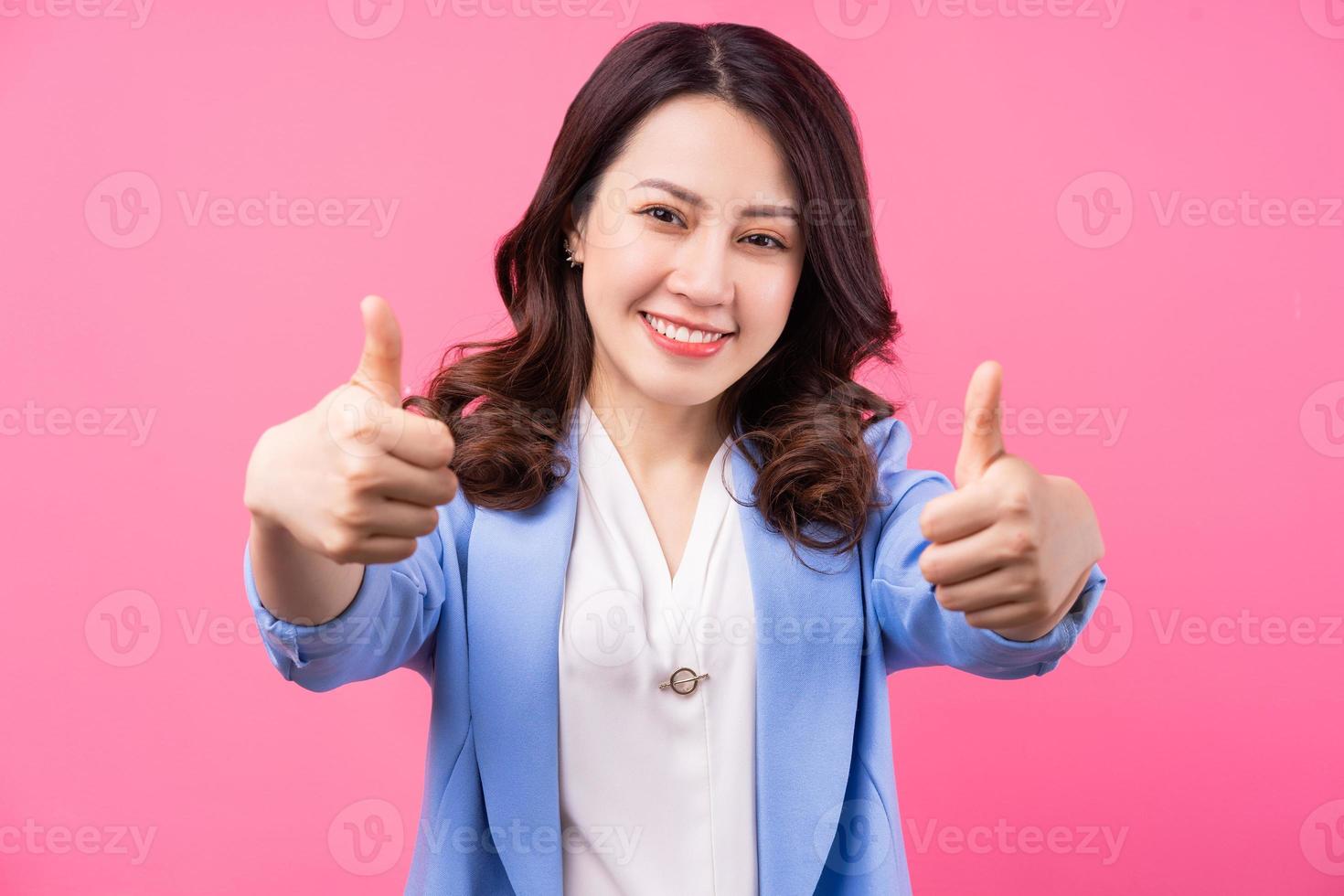 Image of Asian businesswoman on pink bakcground photo