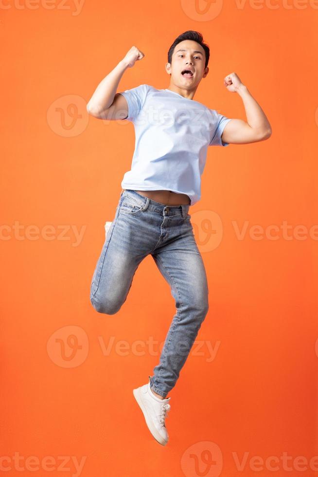 Asian man jumping and shouting photo