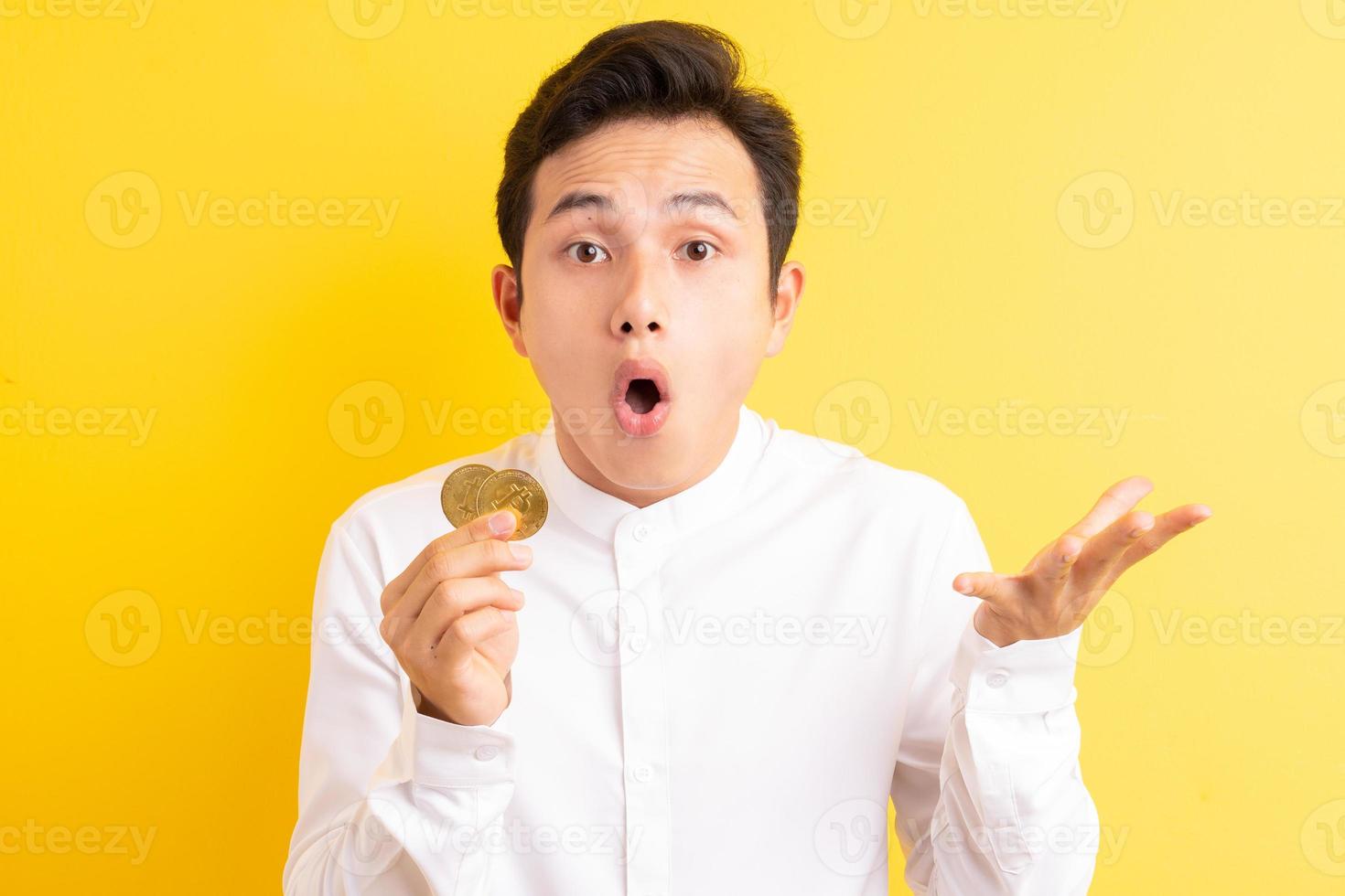 Asian businessman holding bitcoin in his hand wite happy face photo