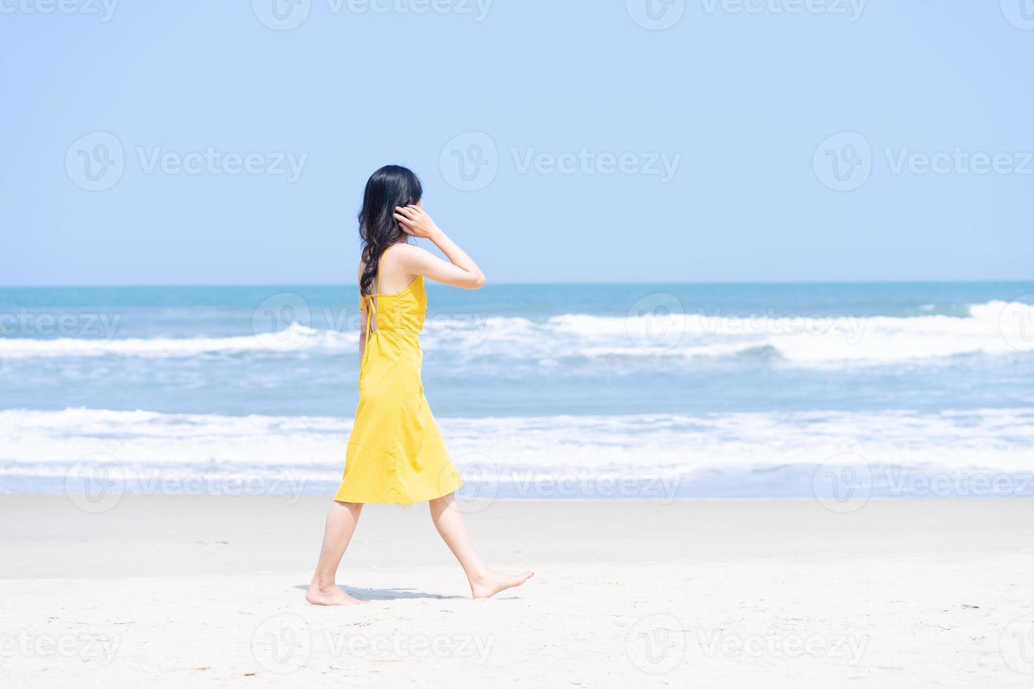 Young Asian woman enjoying summer vacation on the beach photo