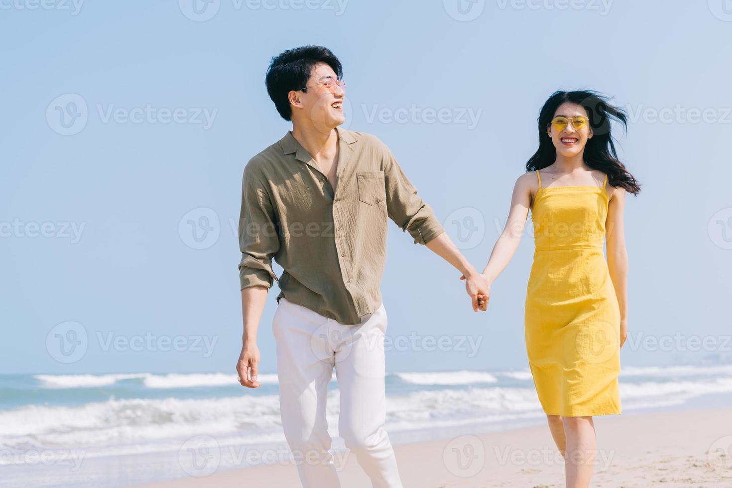 Young Asian couple enjoying summer vacation on the beach photo