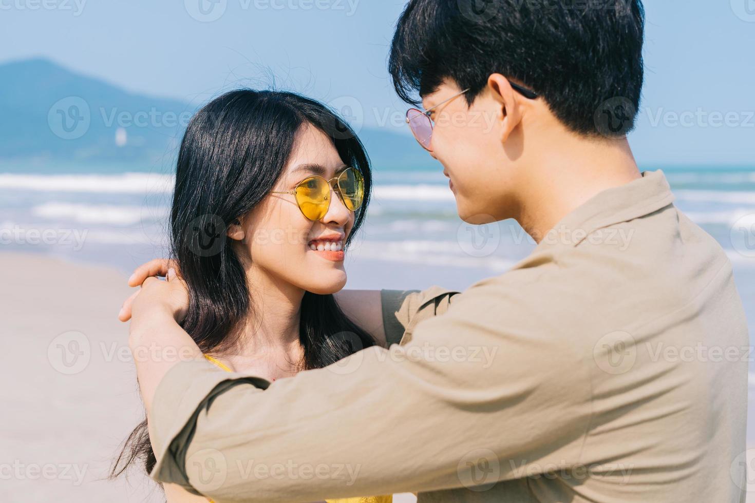 Young Asian couple enjoying summer vacation on the beach photo