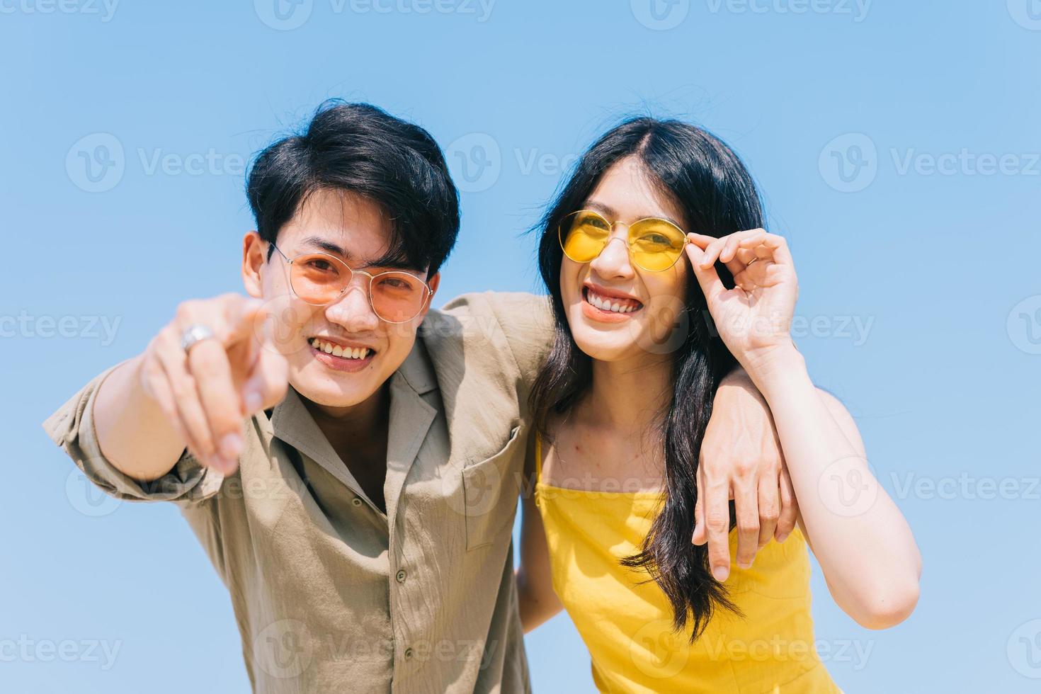 Young Asian couple enjoying summer vacation on the beach photo