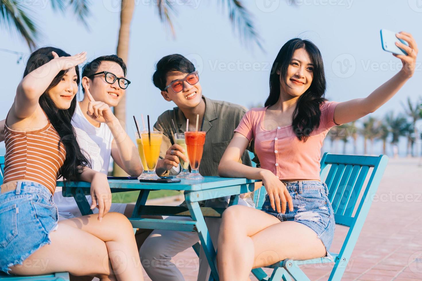 A group of young Asians enjoy a trip to the sea on a summer vacation photo