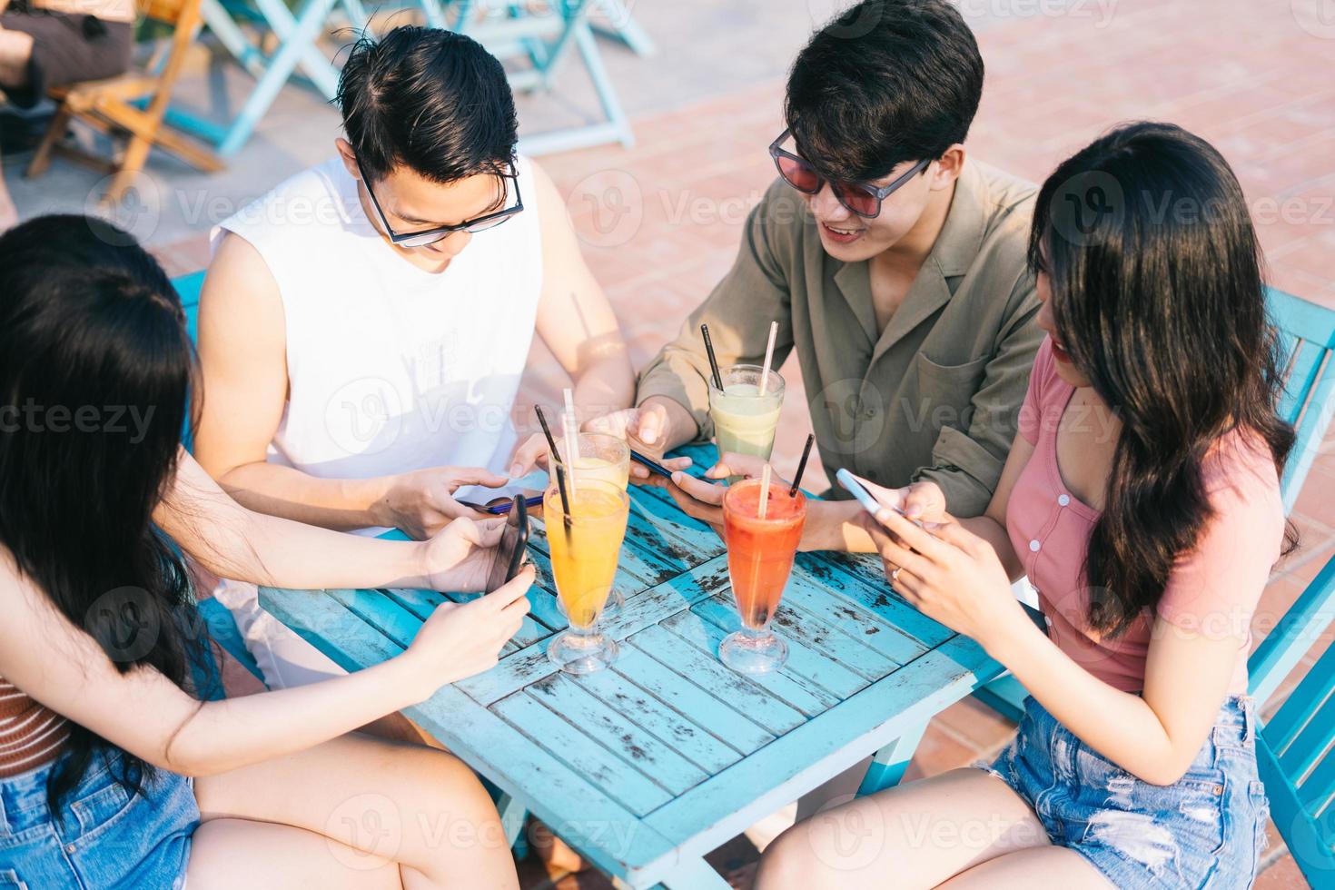 A group of young Asians enjoy a trip to the sea on a summer vacation photo