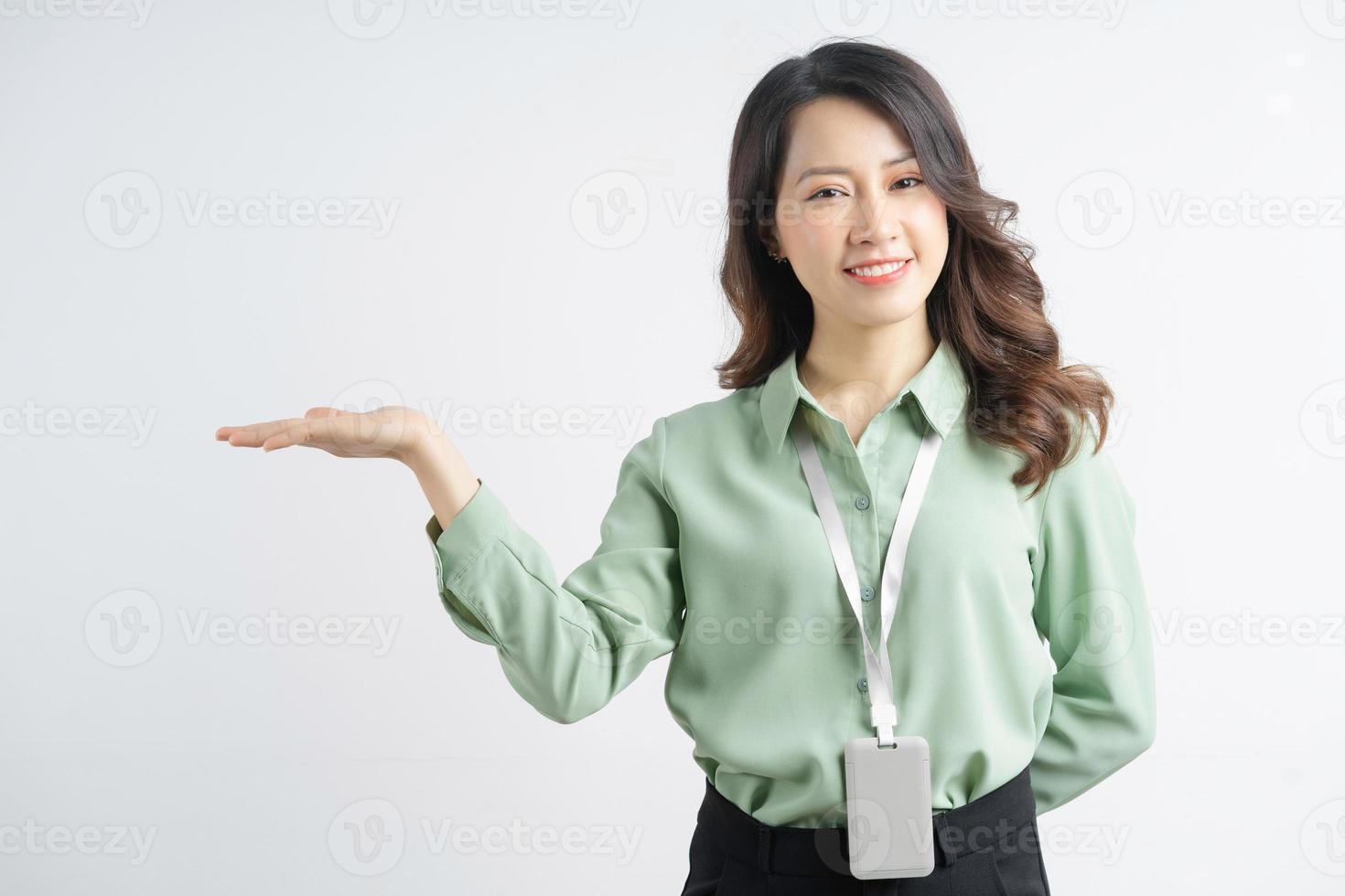 Portrait of a beautiful Asian businesswoman pointing to the side photo