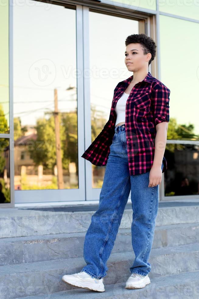 Beautiful African American woman with short hair in the summer on the street photo